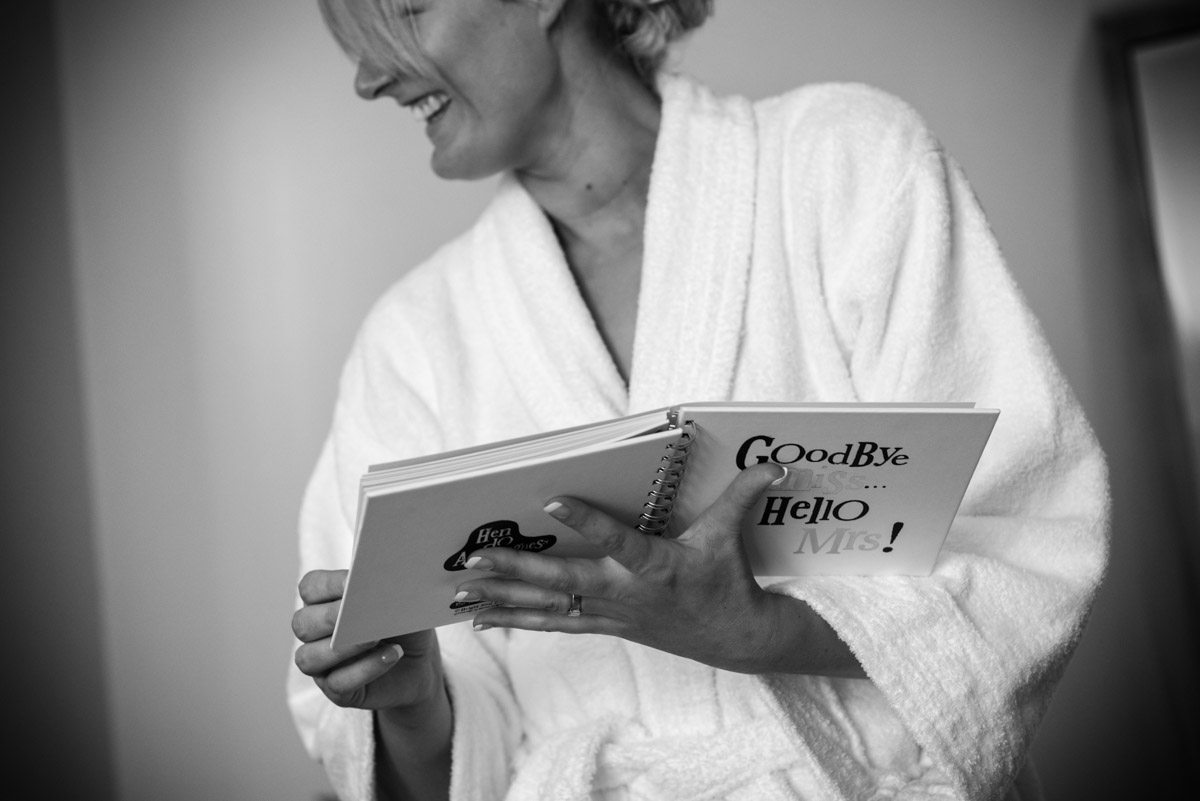 Black and white photograph of Lexy getting ready before her Kent wedding at Allington Castle