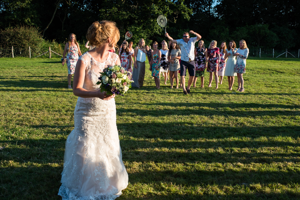 Wedding photograph of Becky throwing her bouquet