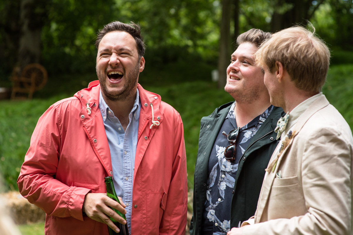 Seb and his wedding guests are photographed laughing together