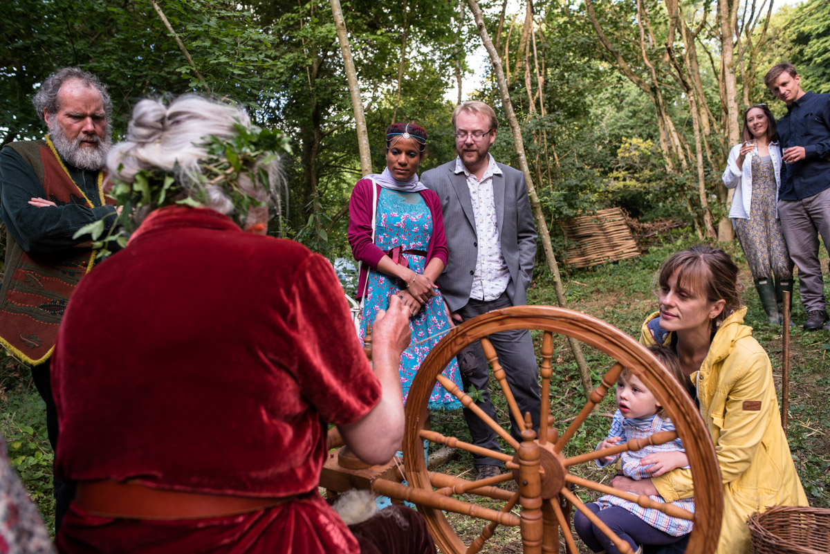 wedding guests watch wool being spun on wheel at Seb and brogans Kent wedding celebration