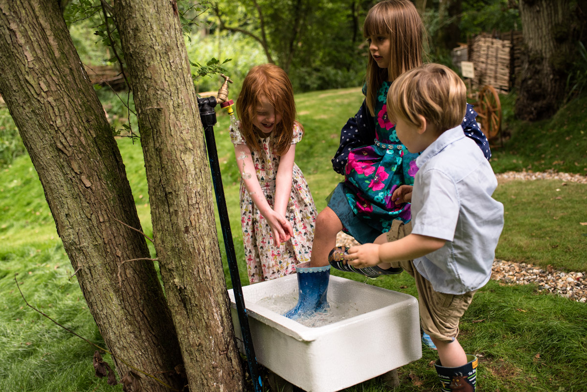 Children are photographed playing in the sink at seb and Brogans wedding celebration in Kent