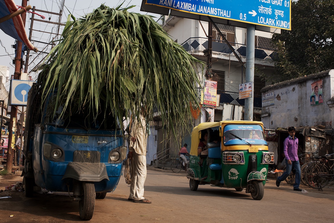 Street photography in Varanasi, man and tuk tuk