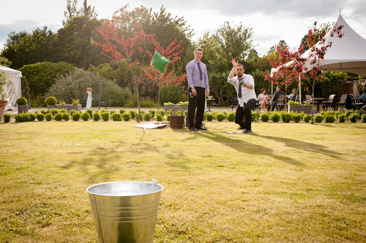 Wedding guests are photographed playing outdoor games at amy and darkness wedding reception