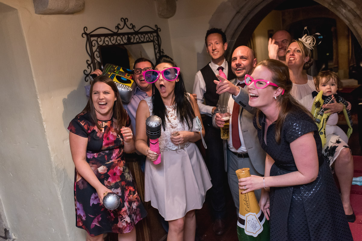 Photograph of wedding guests in funny props at Lianne and Johns reception at Lympne Castle in Kent
