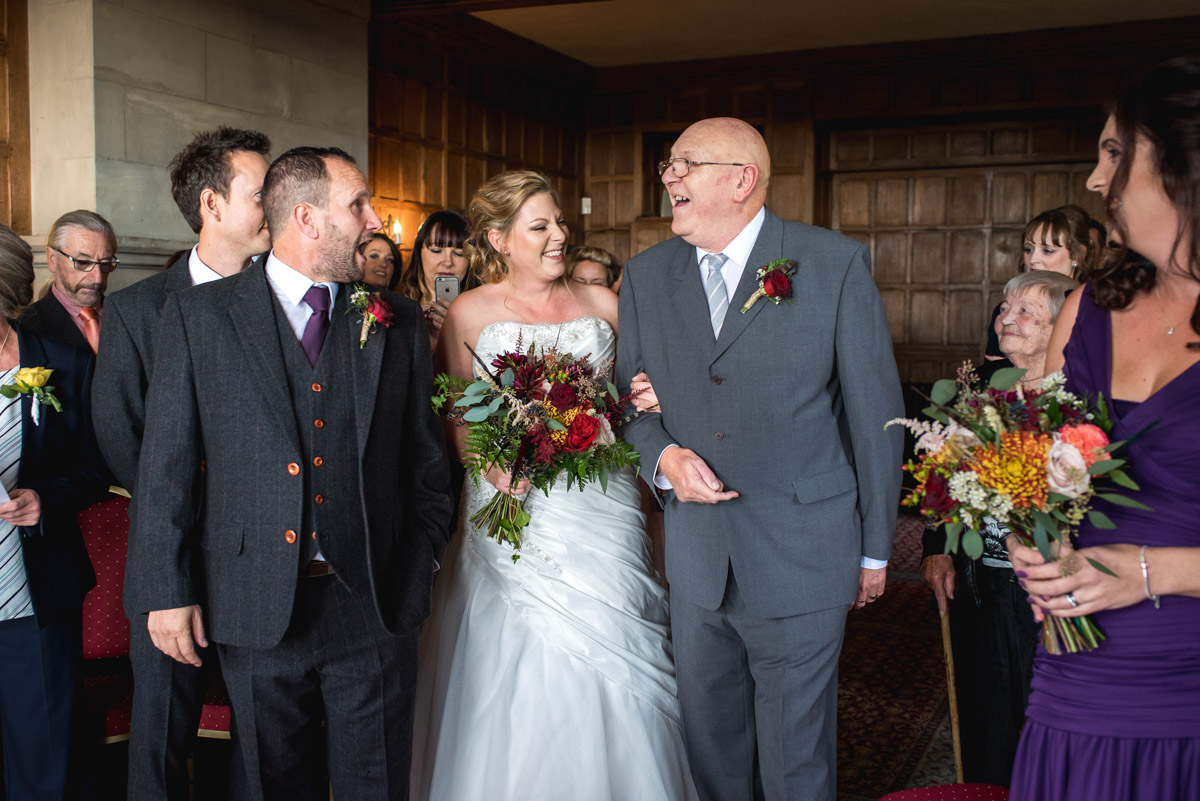 Photograph of Lianne being walked down the aisle at Lympne Castle in Kent for her wedding ceremony