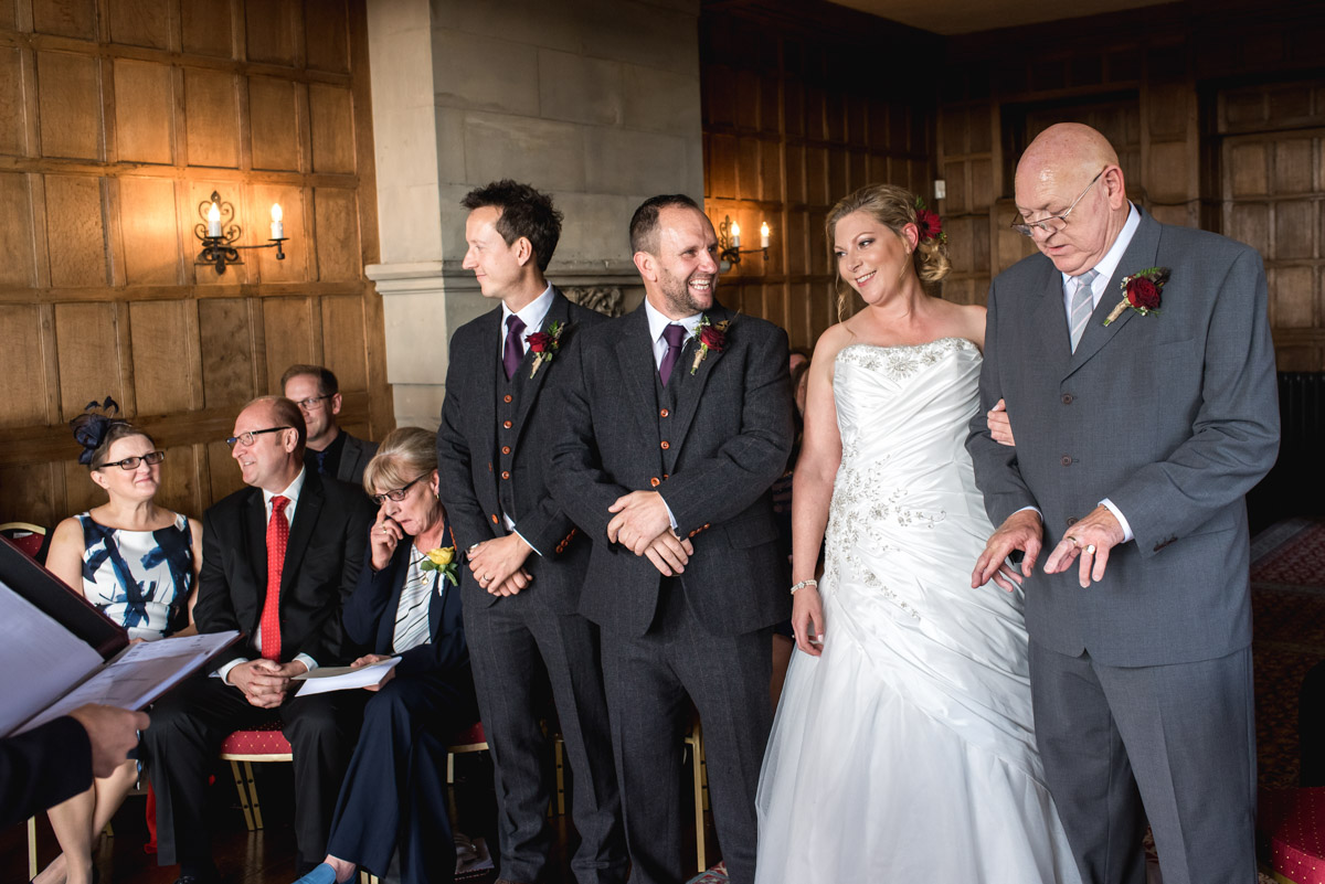Wedding photography at Lympne Castle in Kent. Leanne's dad before presenting his daughter to John during the ceremony