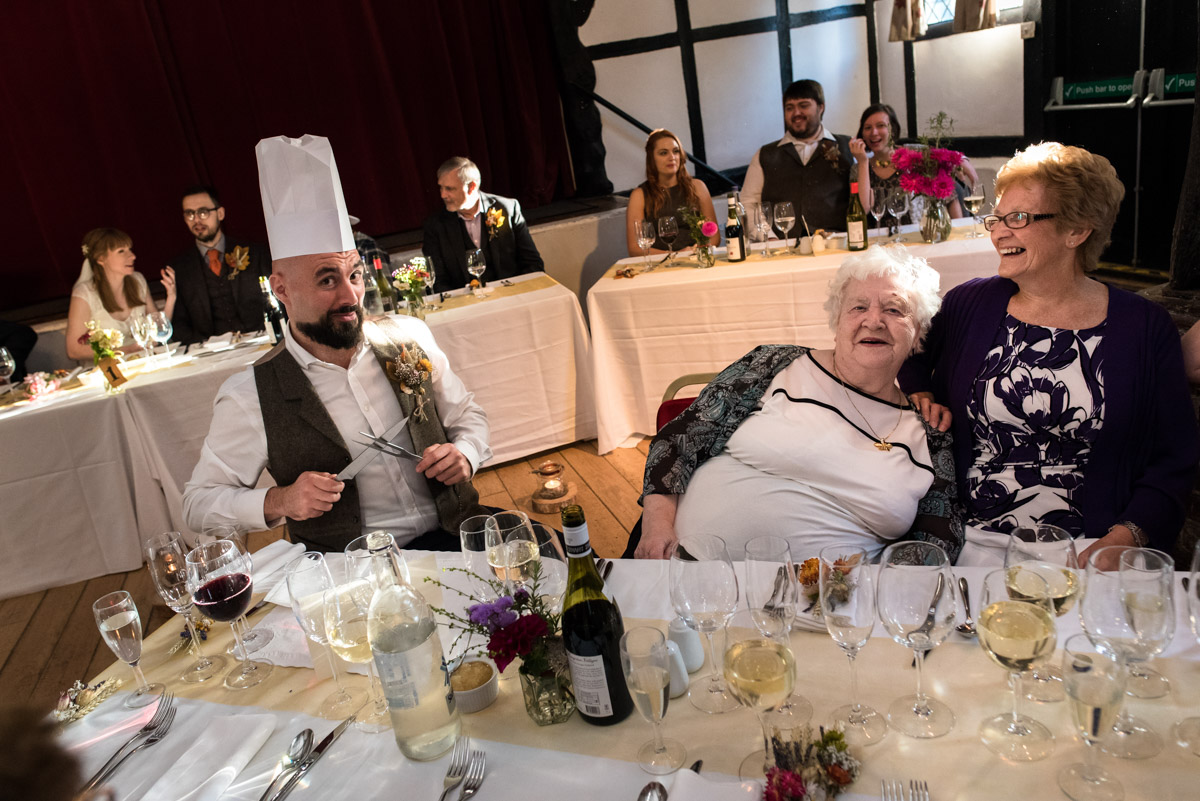 Gusts are photographed preparing to carve during the wedding breakfast at Chilahm Village Hall