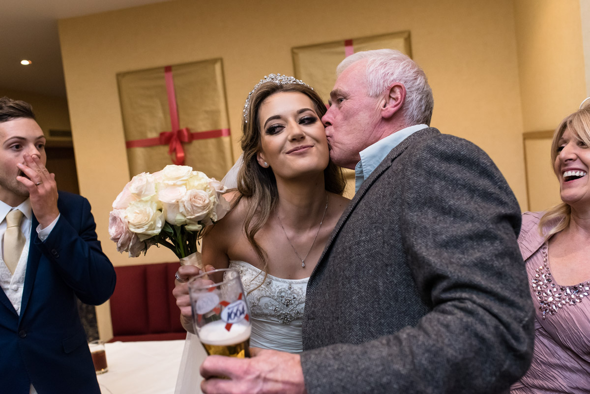 Wedding guests kisses Jades cheek