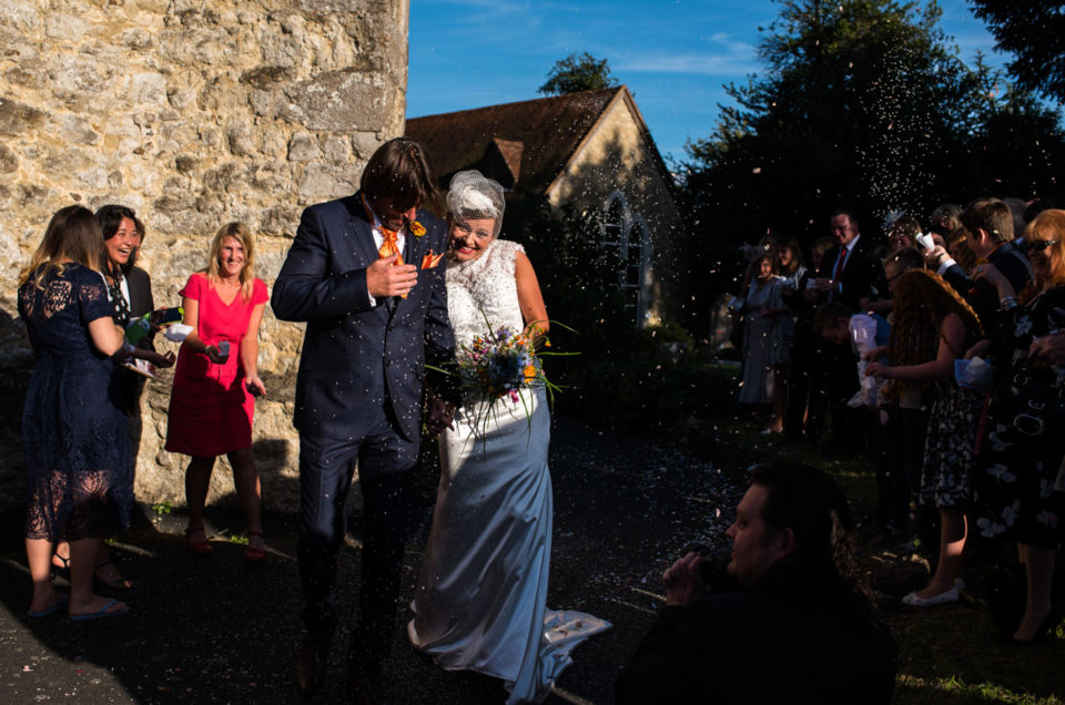 John and Ania photographed in the sunlight after their Kent wedding ceremony