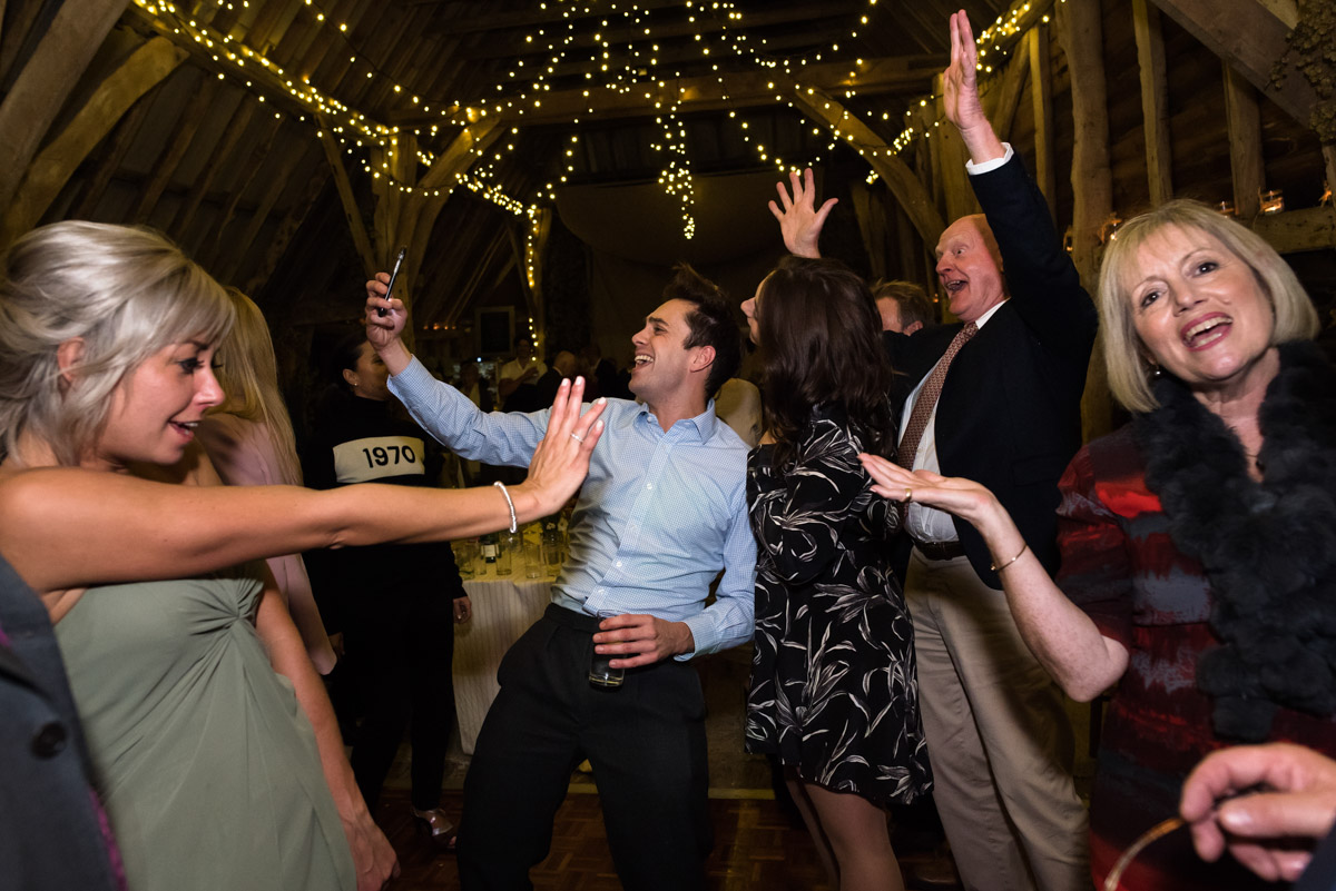 Dancing wedding guests at Jane and Stevens Kent barn reception