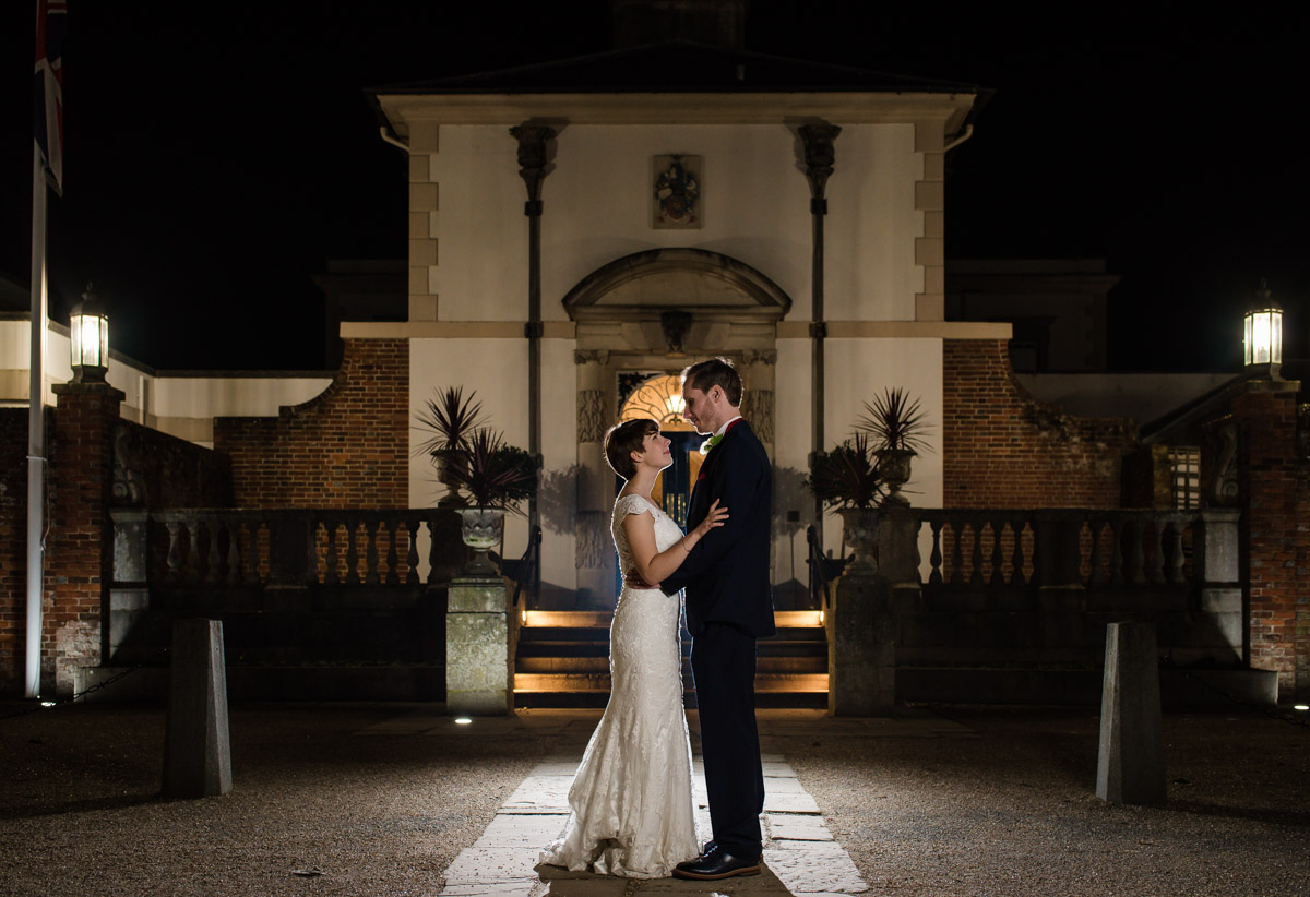 Photograph of Joe and Bennet outside Buxted Park Hotel at night on their wedding day