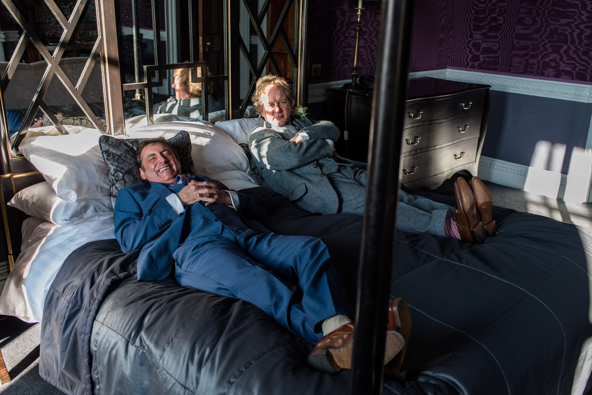 Wedding guests on bed at Buxted park Hotel wedding