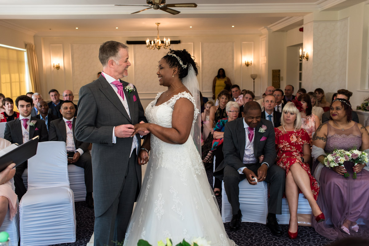 Photograph of darren placing wedding ring on Juliette during Hythe Imperial ceremony