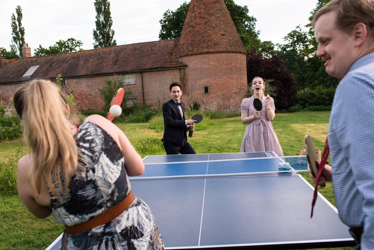 Ratsbury Barn wedding photography, guests play games in the garden