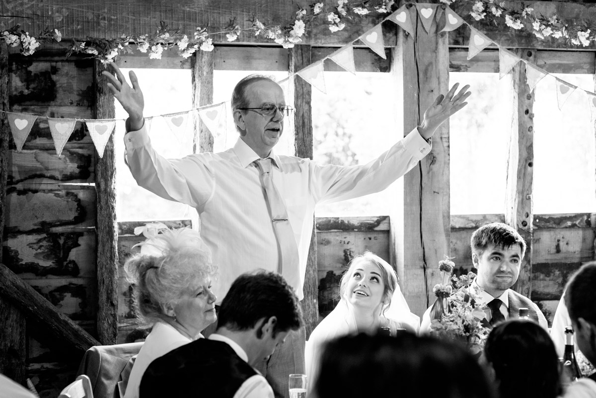 Blacka nd white photograph of brides father making his wedding speech