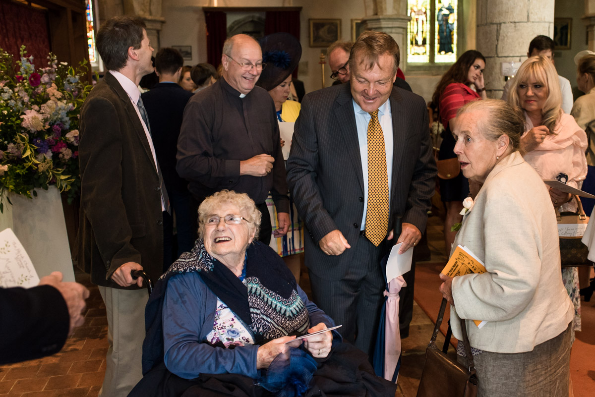 Photograph of wedding guests in church before emily and Toms ceremony