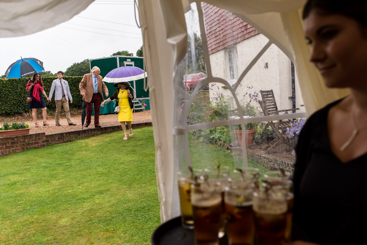 Wedding guests photographed making their way to marquee