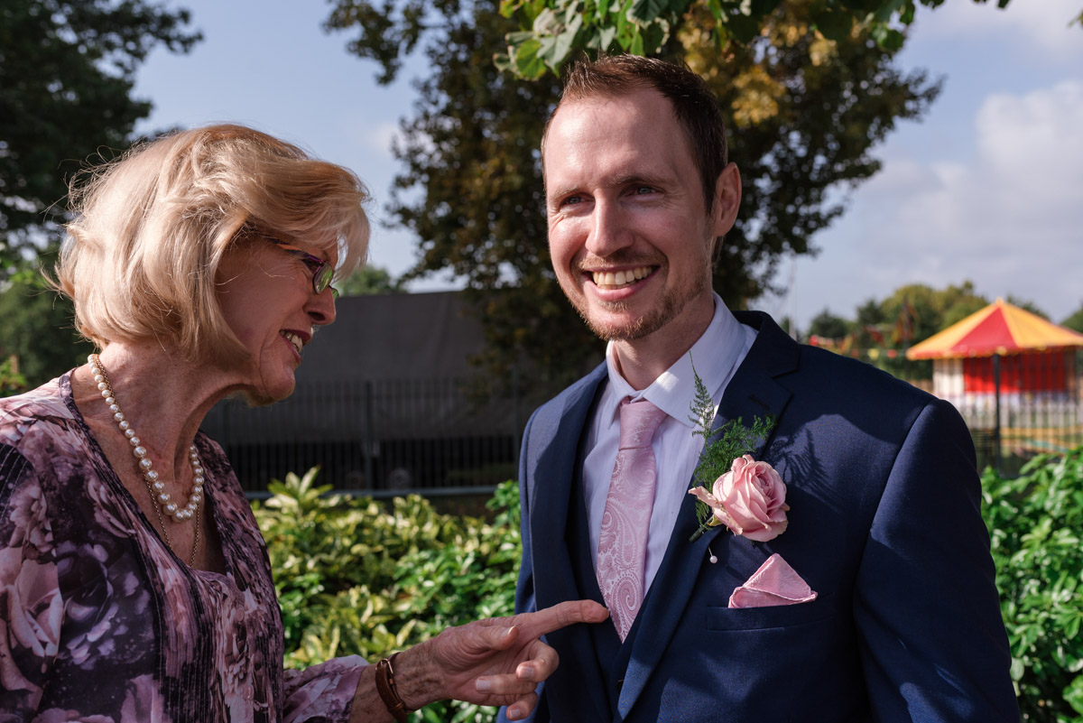 Photograph of button hole being fixed before Johns Danson House wedding