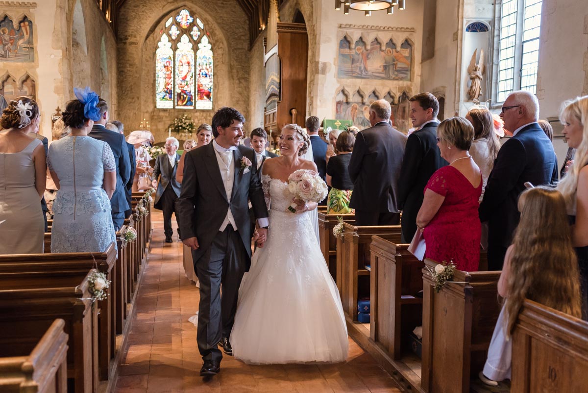Rebecca and James photographed leaving church on their wedding day