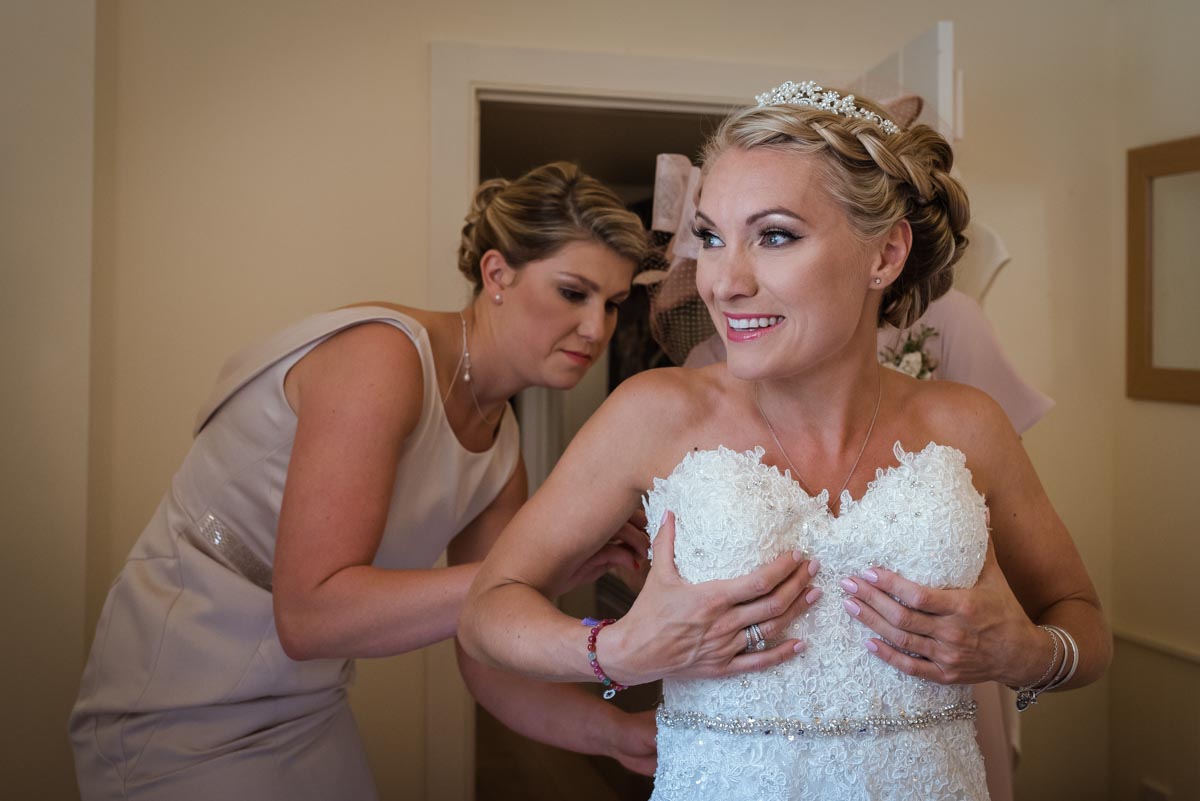 Rebecca is photographed getting her wedding dress on