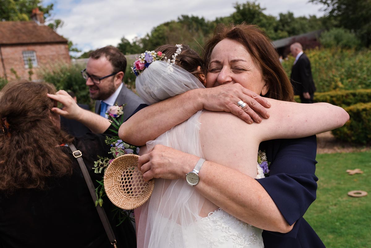 Photograph of bride and wedding guests at the secret garden in kent