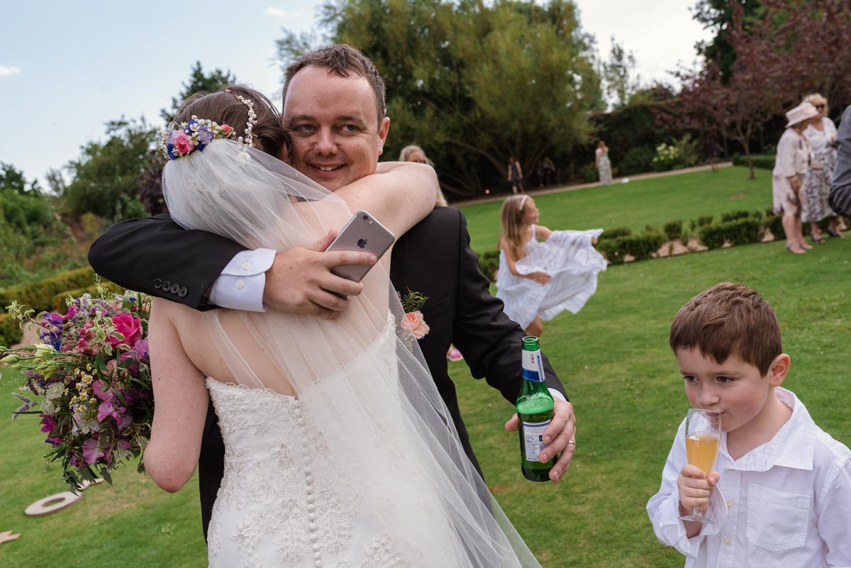 Sarah and her brother hugging on her wedding day