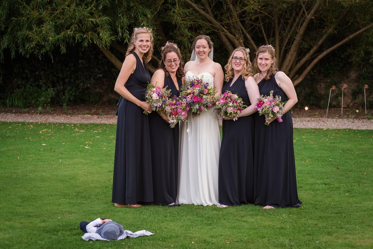 Photograph of sarah and her bridesmaids at her wedding at the secret garden