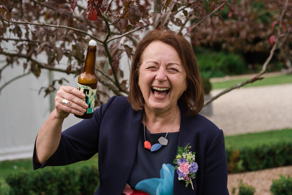 Photograph of the grooms mum at his wedding at the secret garden