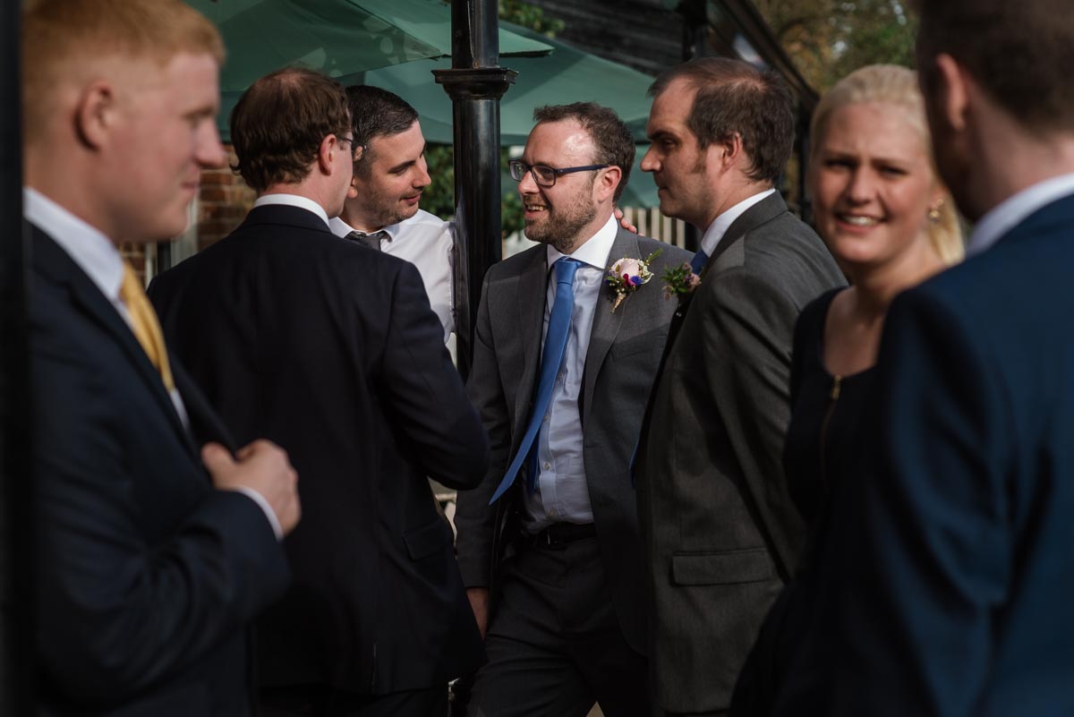 Chris is photographed with friends on his wedding day at the secret garden in Kent