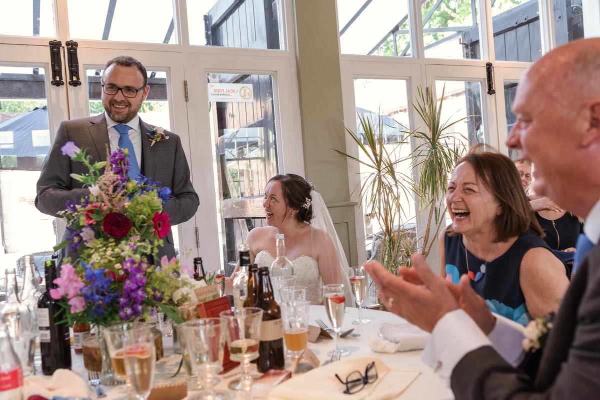 Photograph of chris making his wedding speech at the secret garden in kent