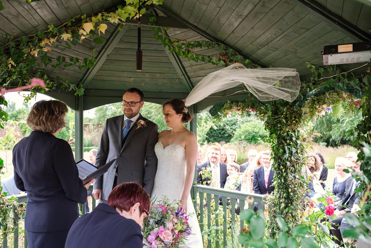 Photograph of wedding ceremony in gazebo at The Secret garden