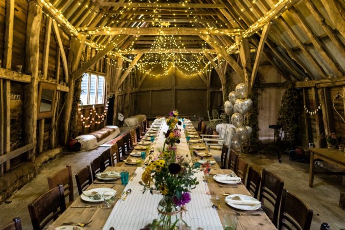 Fairy lights and garden flowers decorate Kent barn for wedding