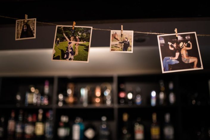 Photos pegged up at wedding reception