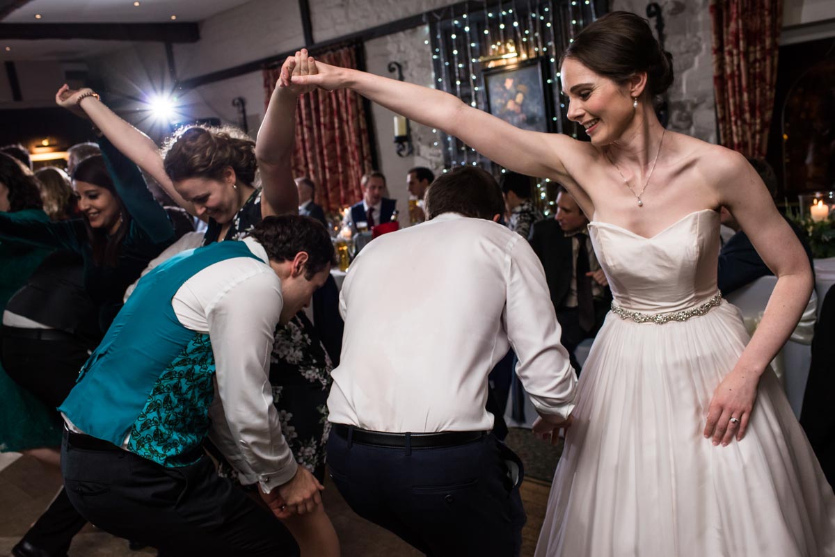 Ceilidh dancing photographed by Kent wedding photographer in Yorkshire wedding venue, Holdsworth House
