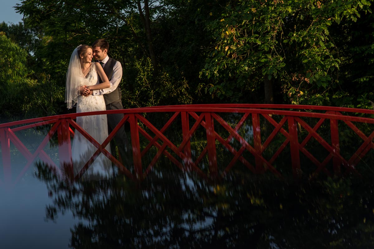 photograph of couple of bridge at ratsbury Barn wedding venue in Kent