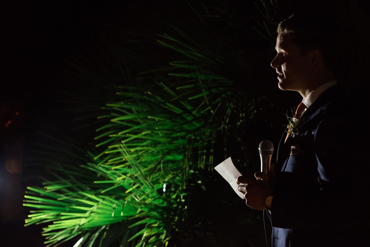Photograph of groom making his wedding speech in the garden