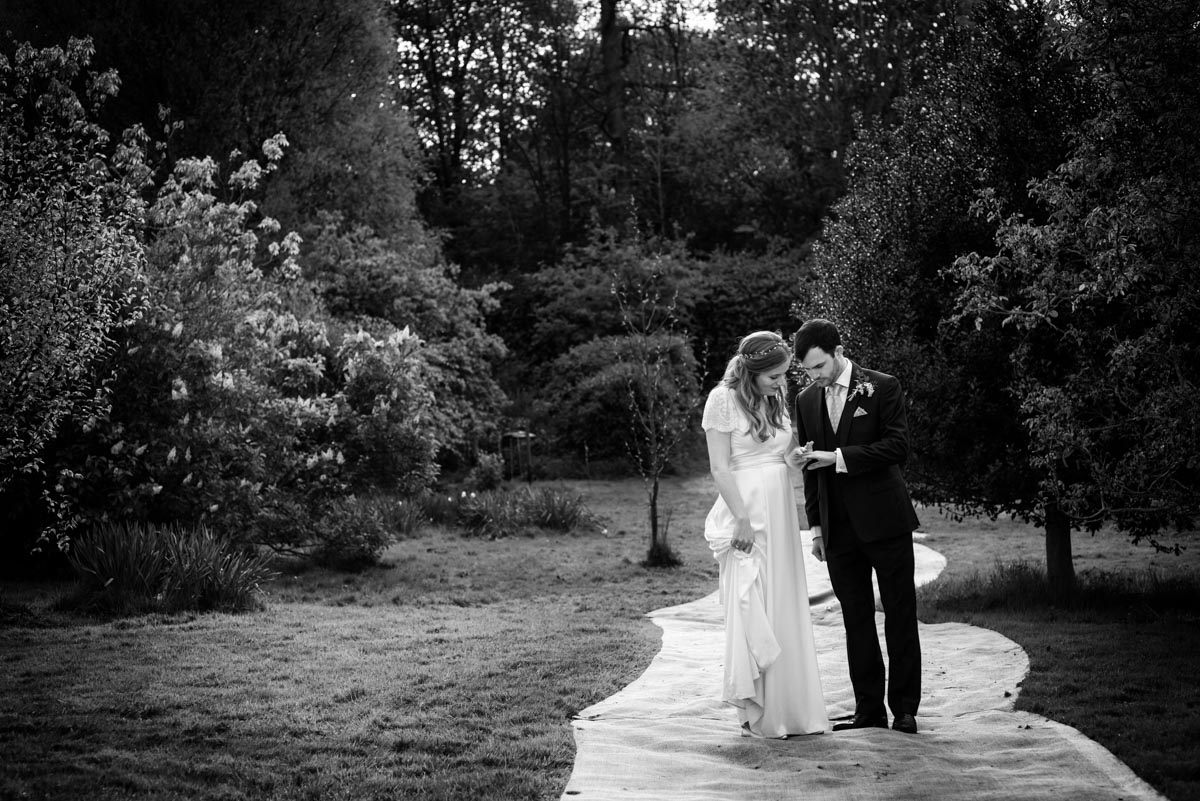 Photograph of couple looking at their wedding rings together