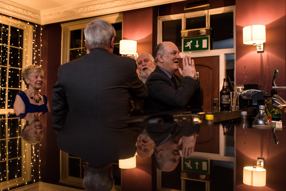 Wedding photography at Chilston park hotel in kent, guests at the bar