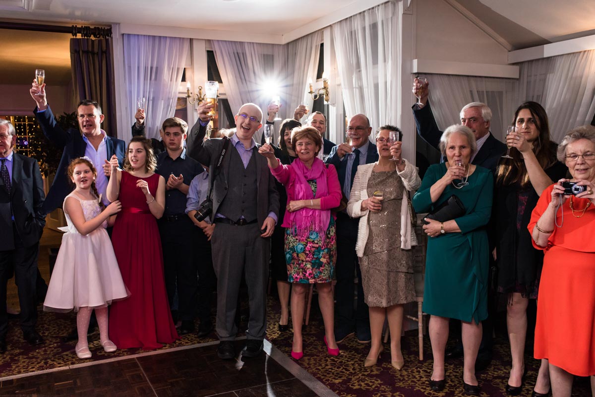 Wedding guests cheer Jo and Graham before their first dance at chilston park hotel in kent