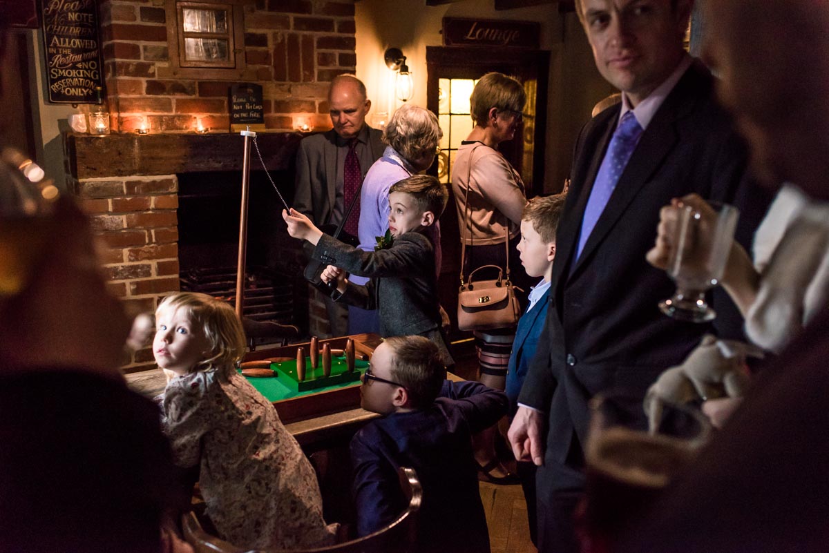 The Ferry House Inn wedding of Rebecca and Stephen. Guests play indoor bar games