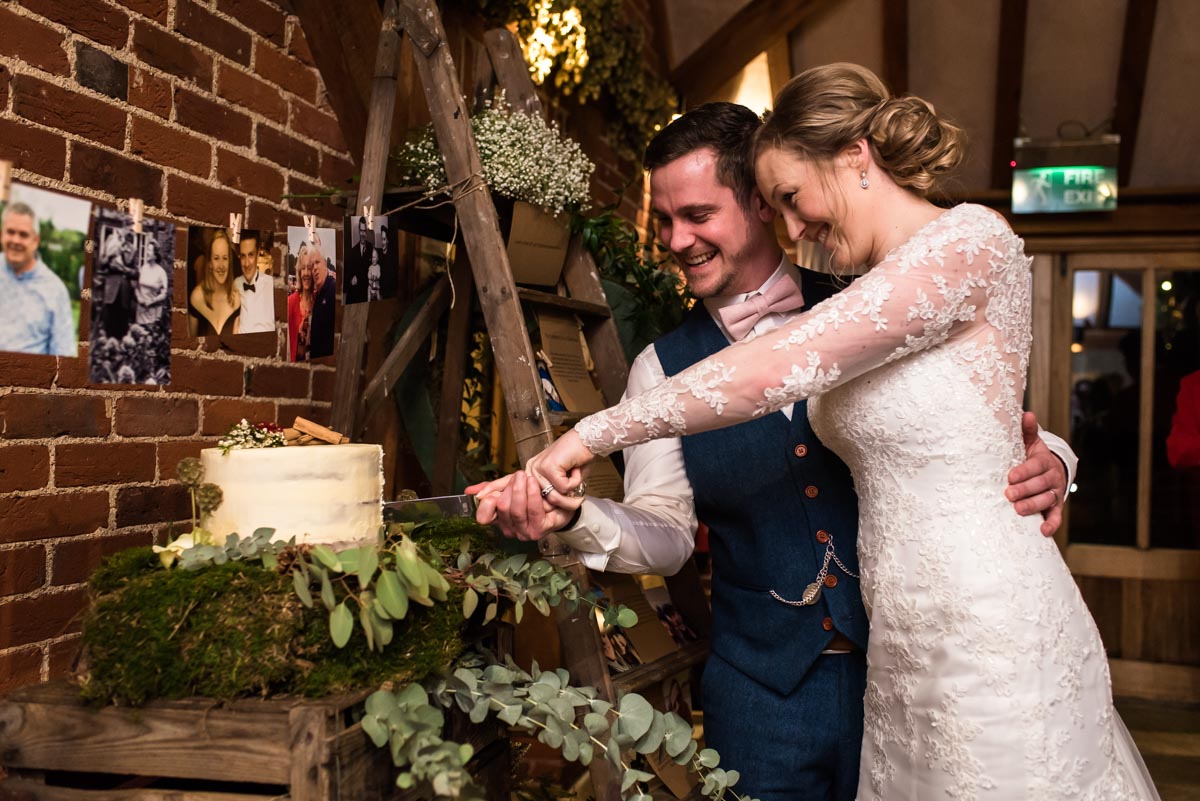 Rebecc and Stephen cutting the cake at Ferry house Inn wedding venue