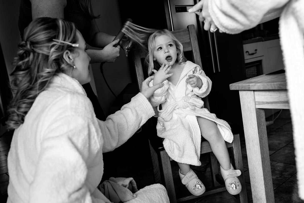 Blacka nd white photograph of Rebeccas flower girl during wedding preparations