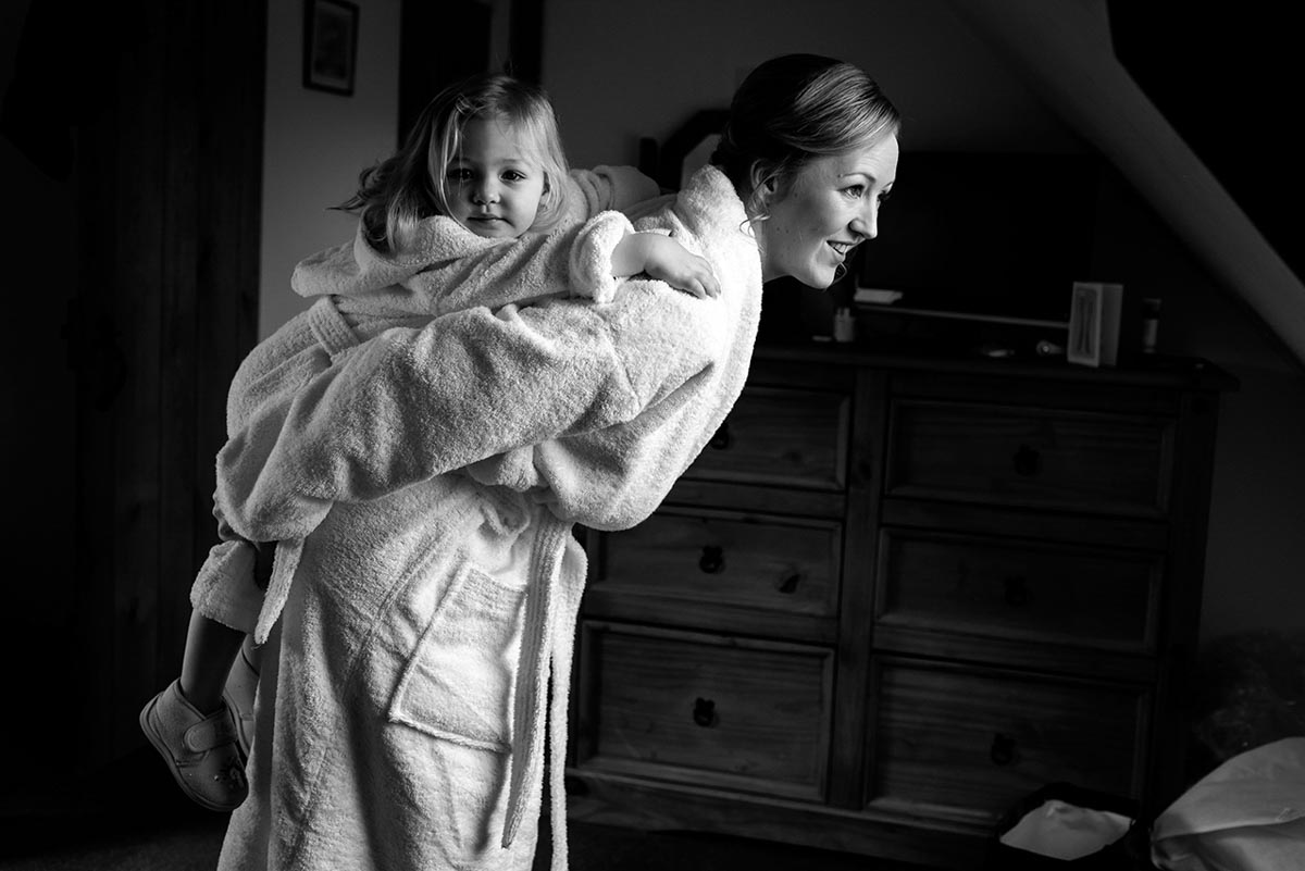 Flower girl gets a piggy back by bride