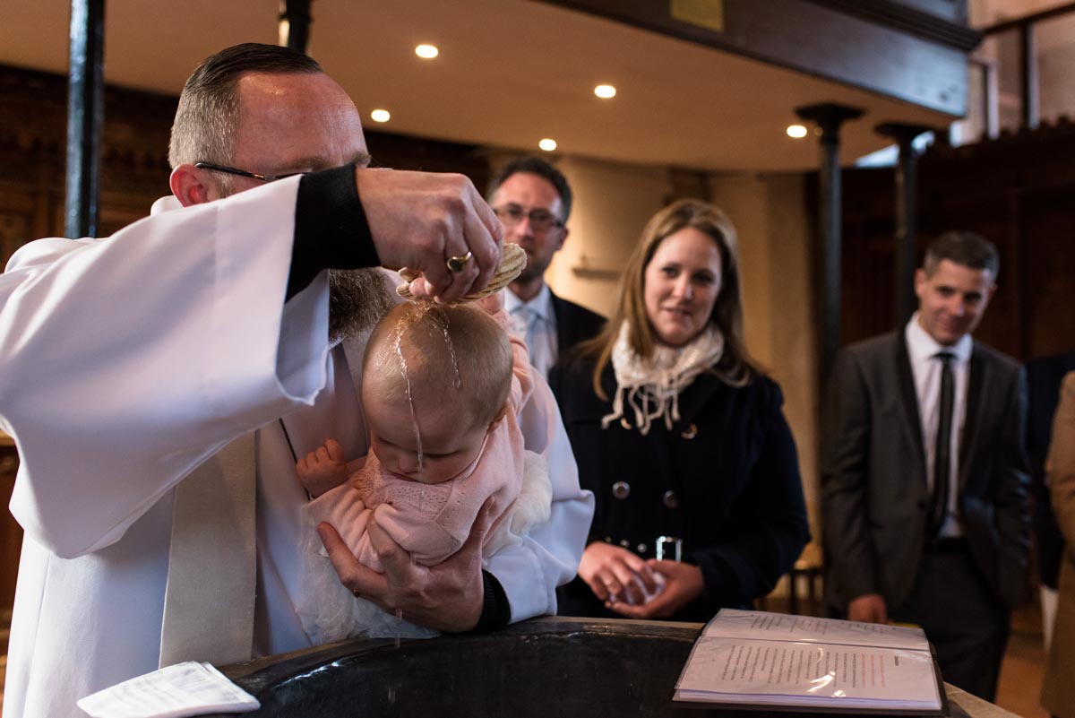 Photograph of Emily being baptised by the vicar in Rolvenden church in Kent