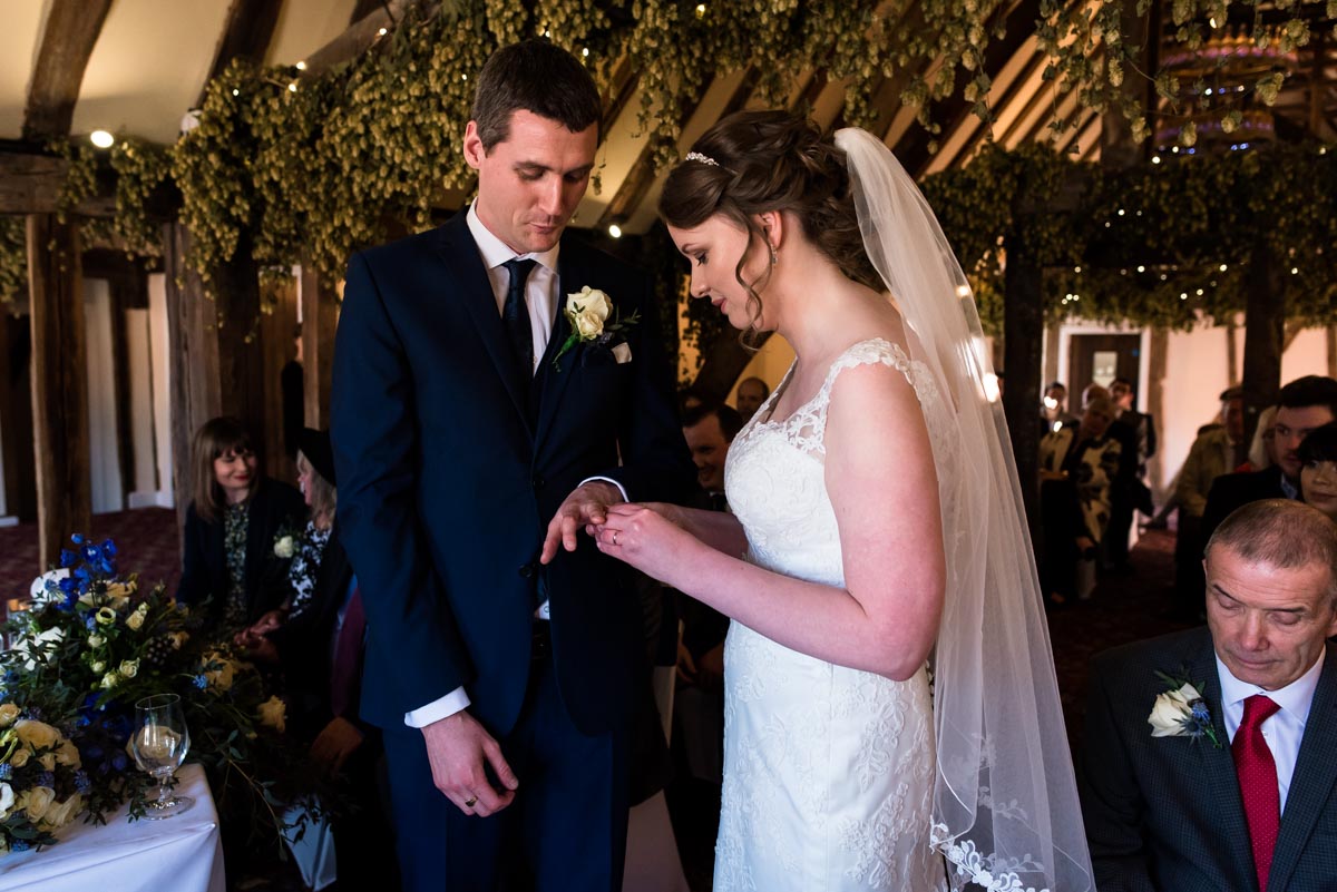 Lindseyplaces Liams wedding ring on finger during ceremony in visitor centre at shepherd neame brewery