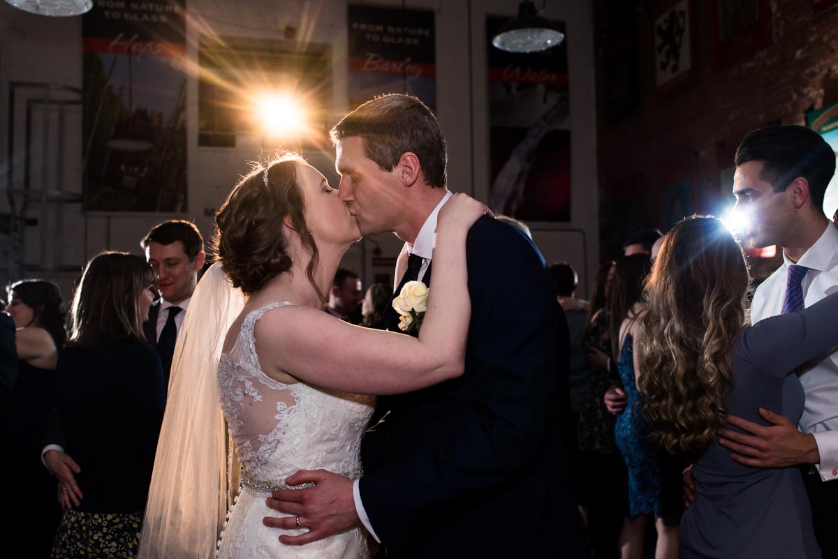 Kissing on the dancefloor. Liam and Lindseys wedding at teh Old Brewery store in Kent