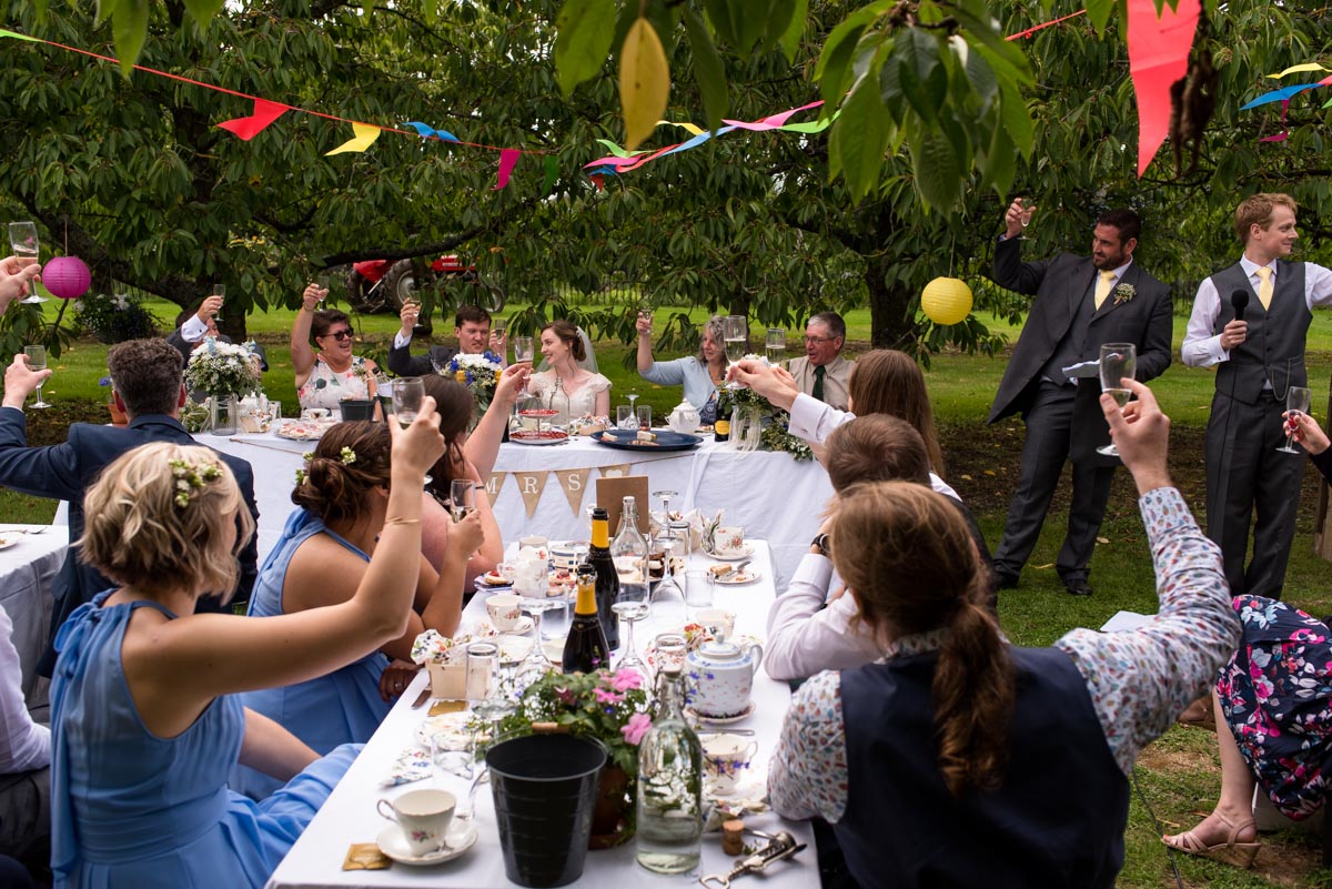 Best Men photographed toasting the bride and groom at their Canterbury wedding