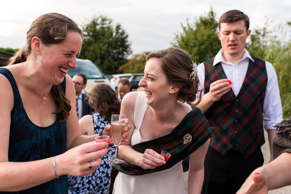 Bride and groom photographed drinking vodka jellies