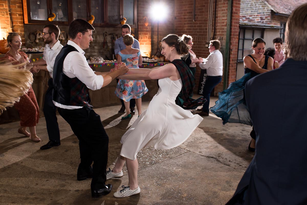 Photograph of bride and groom dancing at their wedding reception Ceilidh