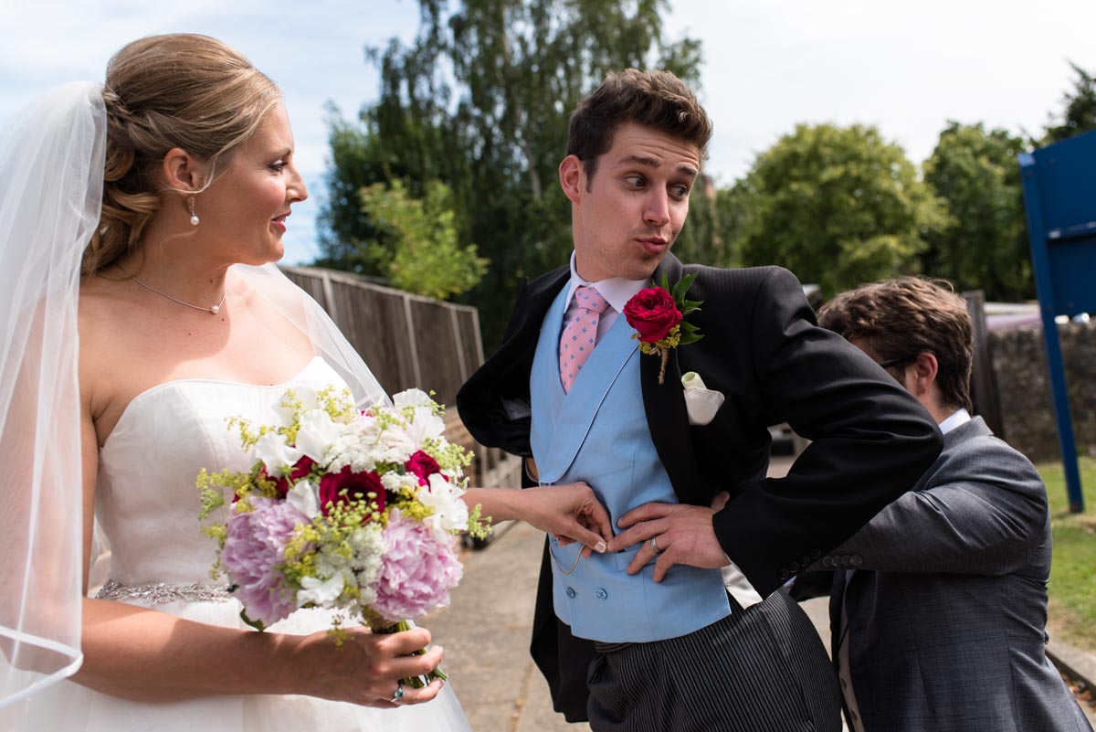 Groom, bride and best man outside Marden Church in Kent